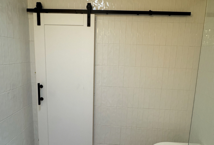 Custom sliding barn door installed in a Perth bathroom